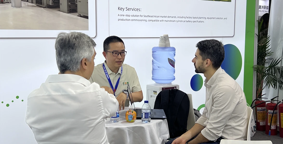 TOB NEW ENERGY technical team demonstrating battery laboratory equipment to international clients